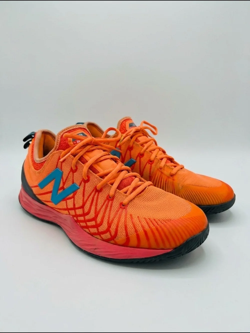 New Balance Men's Orange Running Sneakers with Teal 'N' Logo
